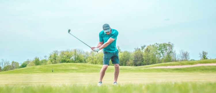 man playing golf on course