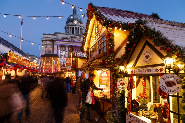 Europe's best christmas markets| NOTTINGHAM, ENGLAND - DECEMBER 22: Man making purchase at Nottingham Christmas Market. In Nottingham, England. On 22nd December 2016.