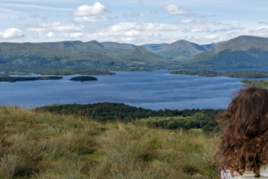 woman sitting overlooking a loch in Scotland