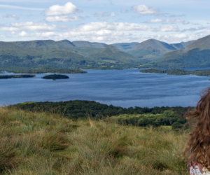 woman sitting overlooking a loch in Scotland