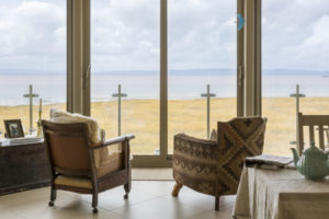 armchairs looking out to the coastal views - Woodhill Beach House, Somerset